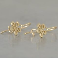 "Five gold leaves make a simple gold flower. These 14k gold earrings are a perfect Christmas gift to your wife and to your daughter. These dainty 14k gold earrings are small and gentle, all solid gold. You can wear these hanging flowers earrings with every kind of necklace: a gold necklace (with a flower pendant), colorful beads necklaces or a classic elegant pearl necklace. Which style would you love to wear these dangle gold earrings with?... Dimensions: * Diameter: 8 m\"m *Profile (width): 1 Gold Flower Charm Earrings In 14k Gold, 14k Gold Earrings With Flower Charm For Gift, 14k Gold Filled Flower Earrings As Gift, Gold Flower Earrings In 14k Gold, Gold Flower Earrings With Flower Charm, Elegant Gold Flower Earrings In 14k Gold Filled, Gold Flower 14k Gold Pierced Earrings, Elegant Gold Flower Earrings 14k Gold Filled, 14k Gold Flower Pierced Earrings