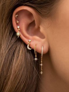 a woman's ear is shown with three stars on the side and one behind her ear