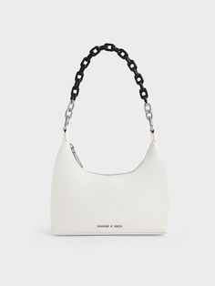 Our Koi chain handle shoulder bag strikes a balance between style and function. It features a striking white finish and two-tone chain handle that adds a touch of glamour to the minimalist design. Where functionality is concerned, a two-way zip closure lets you access your belongings easily, while a detachable shoulder strap offers a hands-free way to carry the bag. Accessorise an all-black ensemble with this classic design to create an eye-catching tonal contrast. Charles And Keith Bags, Black And White Bags, Tas Bahu, White Shoulder Bags, Expensive Bag, Luxury Bags Collection, Tas Fashion, Size Chart For Kids, Airport Fashion