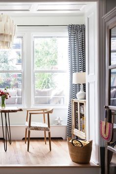 Elevate your space with this inviting corner featuring natural light, airy decor, and minimalist furniture. A woven basket, wooden accents, and patterned curtains bring texture and warmth, while pops of color from fresh flowers add charm. Perfect for reading, relaxing, or small gatherings! Airy Decor, Minimalist Furniture, Woven Basket, Eclectic Style