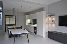 a modern kitchen with white walls and flooring