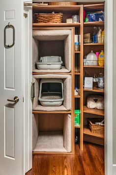 an open closet with several shelves and baskets on the bottom shelf, in front of a door