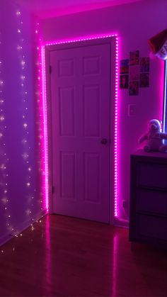 a room with pink lights and a door