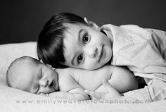 a black and white photo of two babies