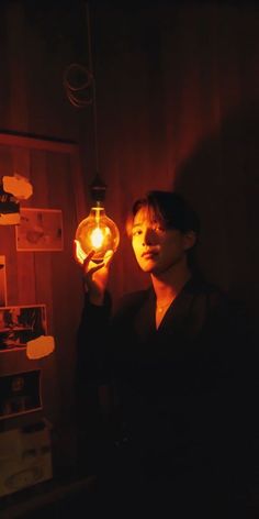 a man holding a light bulb in his hand