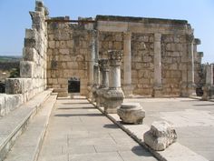 an old building with stone columns and pillars