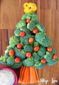 broccoli and carrots shaped like a christmas tree with a bear on top