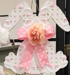 a pink and white paper cutout with a flower on it's center piece