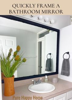 a bathroom mirror sitting above a white sink