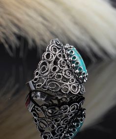 Introducing our Handmade Filigree Art Copper Turquoise Gemstone Lace Detailed Women's Silver Statement Ring! This stunning piece features a unique lace-like design that perfectly complements the striking copper turquoise gemstone at its center. Handcrafted from high-quality sterling silver, this ring is as durable as it is beautiful, and the intricate details make it a true work of art. This ring is an ideal choice for anyone looking for a bold statement piece that's sure to turn heads. It's a p Blue Sterling Silver Filigree Ring, Blue Metal Filigree Jewelry, Ornate Blue Filigree Ring In Sterling Silver, Traditional Turquoise Jewelry With Filigree, Ornate Turquoise Filigree Jewelry, The Ring Face, Statement Ring Silver, Rose Quartz Gemstone, Sterling Silver Filigree