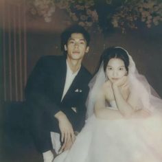 a young man and woman posing for a photo on their wedding day with the bride in a white dress