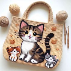 a handbag with an image of a cat and three kittens on it