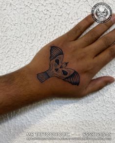 a person's hand with a tattoo on it