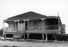 an old black and white photo of a two story house with porches on the second floor