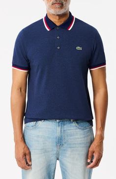 This polo embellished with the signature croc embroidery and a tipped collar is designed for everyday comfort with a classic cut and just-right stretch. Rib collar Short sleeves with rib cuffs 94% cotton, 6% elastane Machine wash, tumble dry Imported Fitted Casual Polo Shirt With Contrast Trim, Sporty Fitted Polo Shirt With Contrast Collar, Dark Indigo, Indigo Blue, Size 4, Short Sleeves, Nordstrom, Embroidery, Collar