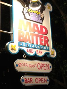 the mad batter restaurant and bar sign is lit up