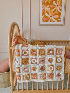 a crocheted baby blanket is in a crib