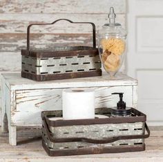 two wooden trays filled with toilet paper and other items