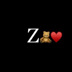 a teddy bear sitting in front of the letter z with a red heart on it