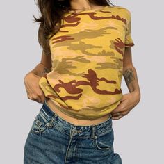 Vintage t-shirt from the 90s. Camouflage pattern in the colors light green/dark red/pink. Size 36/38. crew neck. Fine rib knit. Washable at 30 degrees. Good vintage condition - slight traces of repeated washing, no damage such as tears or holes. The model is a size XS and is 160 cm tall. The clothes will be delivered to you freshly washed or cleaned. / Bust / 50.5 cm / shoulder width / 40.5 cm / length / 53 cm Camouflage T Shirts, Green Dark, Green Brown, Green And Brown, Vintage Tshirts, Dark Red, Womens Clothing Tops, Austria, Light Green