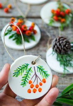 hand painted ceramic ornaments with pine cones and berries