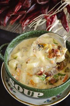 a green bowl filled with soup on top of a table