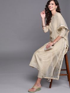 Buy magnificent beige embroidered kurta with pants and dupatta. for women which is crafted from chanderi cotton fabric with beautiful trendy style and pattern. Elegant Cotton Anarkali Set With Gota Work, Cream Chanderi Palazzo Set With Resham Embroidery, Traditional Drape Pant Set For Eid, Semi-stitched Cream Chanderi Palazzo Set, Cream Straight Kurta Anarkali Set In Chanderi, Cream Chanderi Anarkali Set With Straight Kurta, Traditional Beige Sharara With Straight Kurta, Cream Palazzo Set With Straight Kurta For Festivals, Beige Straight Kurta Sharara For Diwali