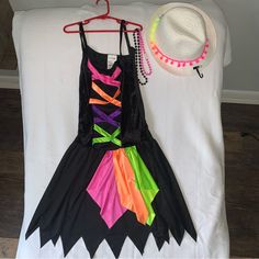 O/S (Fits Childs L) Black Rainbow Dress & Cowgirl Pompom Hat + Necklaces Costume Please Check Measurements As Tag Is One Size Fits Most Measurements- Dress - Worn Once Chest: 15 1/2” Underarm To Underarm Length: 36” Top Shoulder Strap To Long Point Of Hem Measurements- Hat - New, Never Worn Circumference: 22 3/4” Around Inside Height: 5” Approx Pompoms To Top 2 Plastic Bead Necklaces Included - Have Been Worn Very Nice Condition Thank You Playful Black Dress For Costume Party, Black Rainbow, Rainbow Dress, Bead Necklaces, Source Unknown, Pom Pom Hat, Wearing Dress, Kids Costumes, Pom Pom