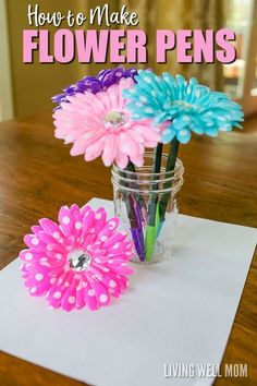 flowers in a mason jar sitting on top of a white paper with the words how to make flower pens