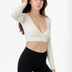 Los Angeles Apparel Cropped Long Sleeve Creme Wrap Top Xs Stretch V-neck Tops With Thumbholes, Fitted V-neck Crop Top For Workout, Fitted Low-cut Top With Built-in Bra, Fitted Spring Activewear With Thumbholes, Fitted Versatile Top For Yoga, Versatile Fitted Top For Yoga, Versatile Fitted Yoga Top, Fitted Cotton Crop Top With Built-in Bra, Fitted Crop Top With Thumbholes