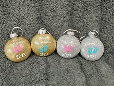 three personalized christmas ornaments on a blanket