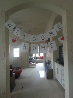 a welcome home banner hanging from the ceiling