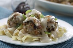 some meatballs and noodles on a white plate