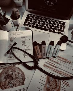 an open laptop computer sitting on top of a desk next to medical supplies and other items