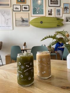 two candles sitting on top of a wooden table