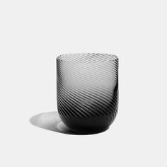 A versatile Tumbler for serving water, juice, or indulging in your favourite rock-based spirits, cocktails, and mocktails. Available in a sultry charcoal hue that catches the light and offers a point of intrigue. The smoky colour emanates from the base of the glass, creating a smooth gradient as it spirals upwards. Whisky Set, Shot Glass Set, Dip Bowl, Highball Glass, Flute Glass, China Mugs, Water Jug, Espresso Cups, Side Plates