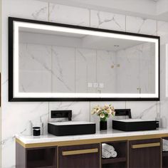 a bathroom vanity with a large mirror above it