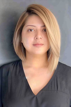 An asymmetrical long bob on a woman with a full, round face, showcasing a flattering hairstyle. Asymmetrical Long Bob