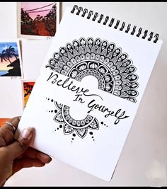 someone holding up a spiral notebook with the words believe in yourself on it, surrounded by pictures