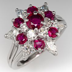 This beautiful ring is centered with a four-prong set, round cut ruby, surrounded by six (6) prong set, round brilliant cut diamonds. The top of the ring is accented with six (6) smaller, round mixed cut rubies and six (6) pear brilliant cut diamonds in prong settings. The ring measures 16.4mm at the top, rises 10.6mm above the finger, tapering to 1.4mm wide and 1.0mm thick at the base of the shank. This ring is currently a size 4.5. Red Cluster Ring With Brilliant Cut, Red Cluster Ring With Brilliant Round Cut, Classic Red Cluster Diamond Ring, Luxury Red Cluster Ring, Red Cluster Diamond Ring With Brilliant Cut, Red Cluster Ring With Prong Setting, Red Cluster Ring With Prong Setting, Round Cut, Red Diamond Cluster Ring With Vvs Clarity, Red Round Cut Cluster Ring With Prong Setting