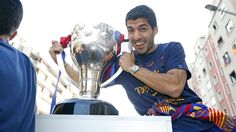 a man sitting on top of a white box holding a silver trophy in his right hand