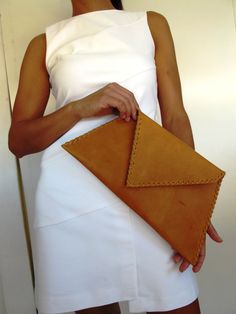 Large leather clutch with decorated hand stiches. Hard interface has been used for not loosing its asymetrical shape. Here shown in natural tanned color. DETAILS Size: aprox. width 38cm-15 inches x length 20cm-7,9 inches It has inside pocket closing with zipper. With magnetic clasp. No shoulder strap can be add in this design. In 3 colors : natutal tanned, black and dark brown. Please, choose the color you prefer. If you don't, we will send you the listing color. We are working with great qualit Magnetic Clasp, Leather Clutch, Evening Bags, Clutches, Dark Brown, Greece, Leather, Design