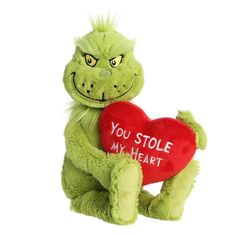 a green stuffed animal holding a red heart with the words you stole my heart written on it