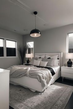 a large white bed sitting in a bedroom on top of a gray carpeted floor