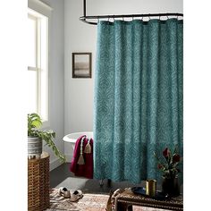 a bathroom with a shower curtain and rug