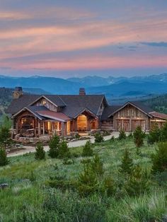 a large house sitting on top of a lush green hillside