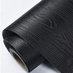 a roll of black woodgrain paper