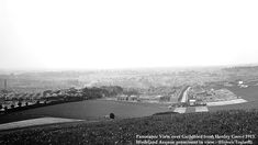 black and white photograph of an aerial view of a city from the top of a hill