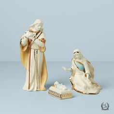 two porcelain figurines, one with a baby jesus