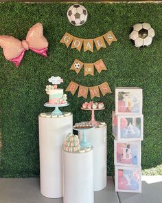 a soccer themed birthday party with pink and gold decorations on the wall, cupcakes and cake